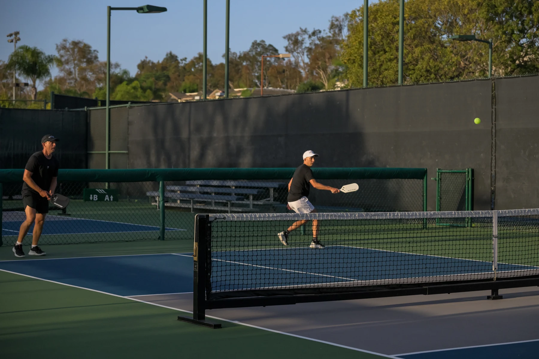 Doubles play on a sunny court