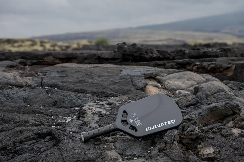 Black APEX paddle on rocks — landscape